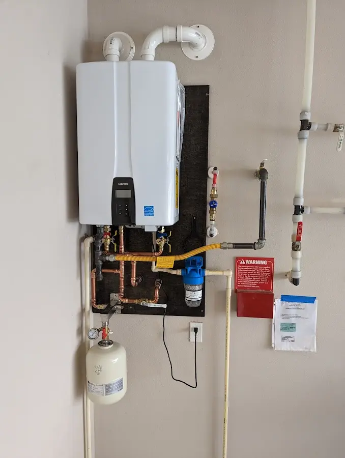 Professional plumber installing copper piping in a Payette home